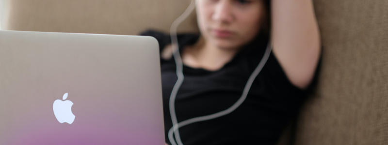 ソファに座ってパソコンを使う女性